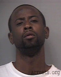 a mug shot of a man in a white shirt