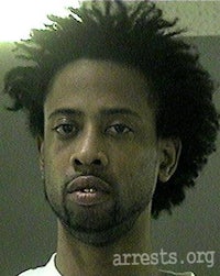 a mug shot of a man with afro hair
